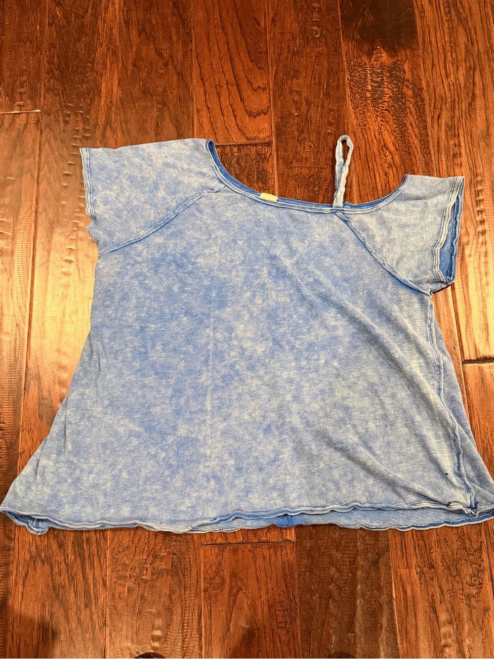 Blue Free People cold-shoulder T-shirt with a raw hem and acid wash finish.